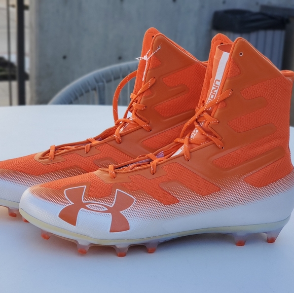 orange and white under armour football cleats